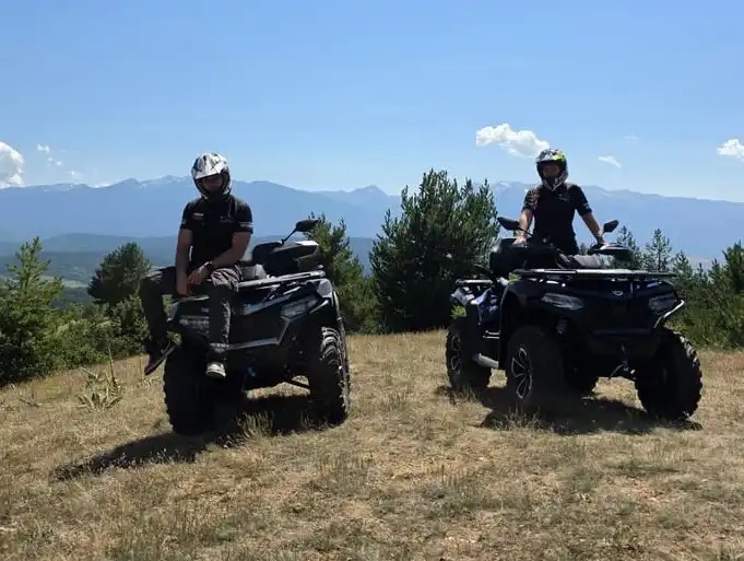 Family on 2026 CFMOTO 625 quads on a forest track in the Pirin Mountains near Bansko, Bulgaria